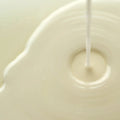 Axis-Y Dark Spot Correcting Glow Toner texture reference. The image shows a milky liquid that is being poured.
